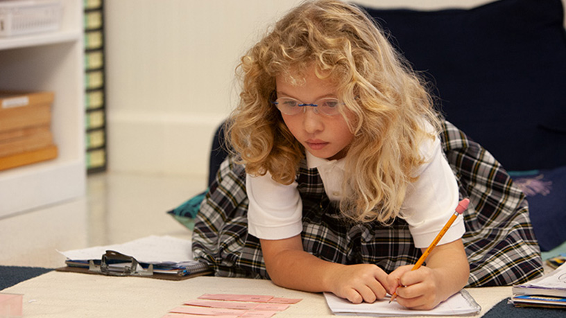 Young child writing in journal